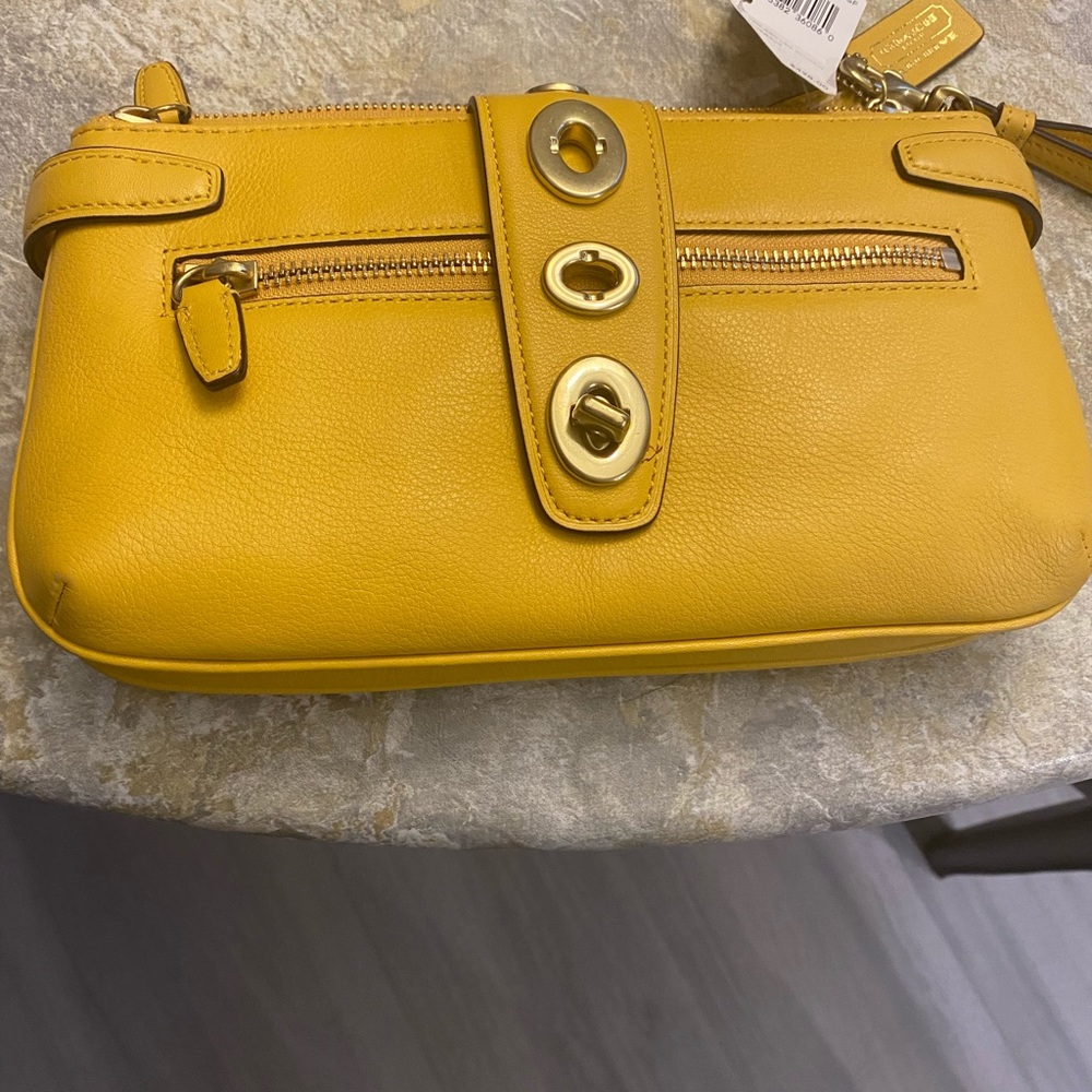 Dark yellow Coach wristlet